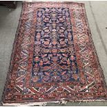 Middle Eastern wool rug with geometric pattern on blue & red ground 202x117cm