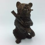 Bronze bear smoking a pipe in the form of a match strike