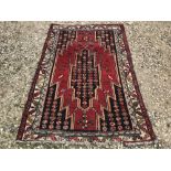 Rug, with stylized all over patterns from red ground to multi medallion panels 188x122cm