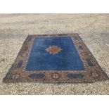 Large Persian rug with blue background & brown surround 335x280cm