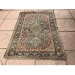 Early C20th Kashmir wool rug with central motif on a blue background 195x134cm