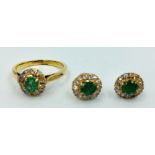 Emerald & diamond ring in unmarked yellow metal, central old cut emerald with a surround of single