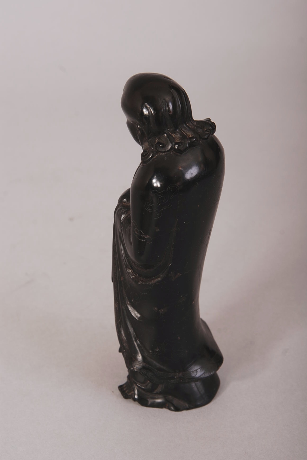 C18th/19th Chinese hardstone figure of Luohan, shown standing with his head turned slightly to the - Image 2 of 2