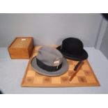 Bowler hat & grey hombury, wooden chess board with modern resin pieces
