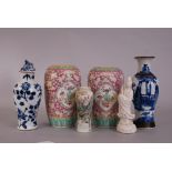 Pair of C19th Chinese famille rose jars, painted with panels of vases, flowers and scrolls,