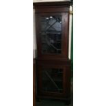 Early C20th oak freestanding corner cupboard in two sections