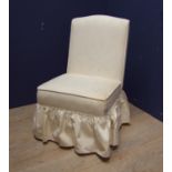 Nursing chair, covered in cream damask