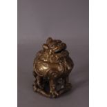 C17th/18th Chinese bronze Luduan-form censer, the beast cast standing with the globular body forming