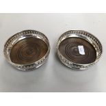 Pair of hallmarked silver bottle coasters with pierced rims, London 1966