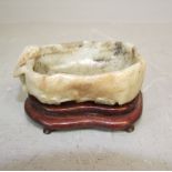 Carved jade Chinese brush washer as an animal looking into a pond on carved hardwood stand