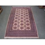 Middle eastern wool rug in greys/pinks & black with a geometric brown pattern