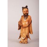 C17th/18th Chinese carved soapstone figure of an immortal, shown standing and wearing loose robes