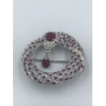 Silver & ruby brooch in form of a coiled snake