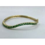 Unusual serpentine shaped emerald bangle