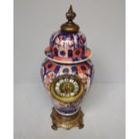 Oriental Imari porcelain and gilt metal clock, the body as a lidded case, the base and clock face