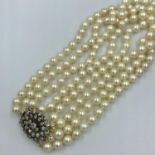 4 Strand early C20th pearl necklace of ivory hue with old cut diamond clasp