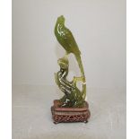 C20th Chinese green jade figure of a bird of paradise 20cm H on carved hardwood base