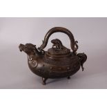 C19th Chinese bronze tripod ewer and cover, with dragon-form handle and the body is decorated