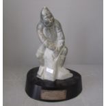 Inuit carved stonefigure on a wooden base with a presentation plaque