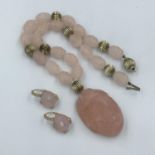 Rose quartz & yellow metal curved pendant necklace together with a pair of matching earrings