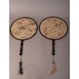 Two C19th Chinese silk circular fans, each mounted in a lacquered-wood frame with handle, one