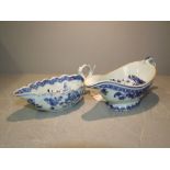 Chinese blue & white sauceboat decorated with figures by a Pagoda (chips to base) & another with