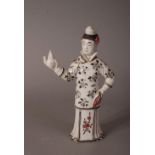 C19th/20th Chinese white glazed lady-form teapot and cover, painted in black and red with floral