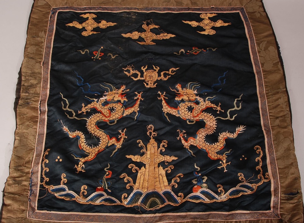 C17th Chinese silk embroidered panel, woven with two dragons chasing a flaming pearl above