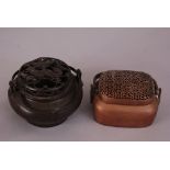 Two C19th Chinese bronze handwarmers, one of circular form and with marks to base, and the other