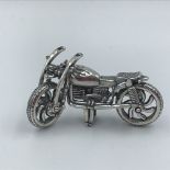 Silver figure of a motorbike