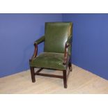 Heavy mahogany library armchair covered in dark green leather style material