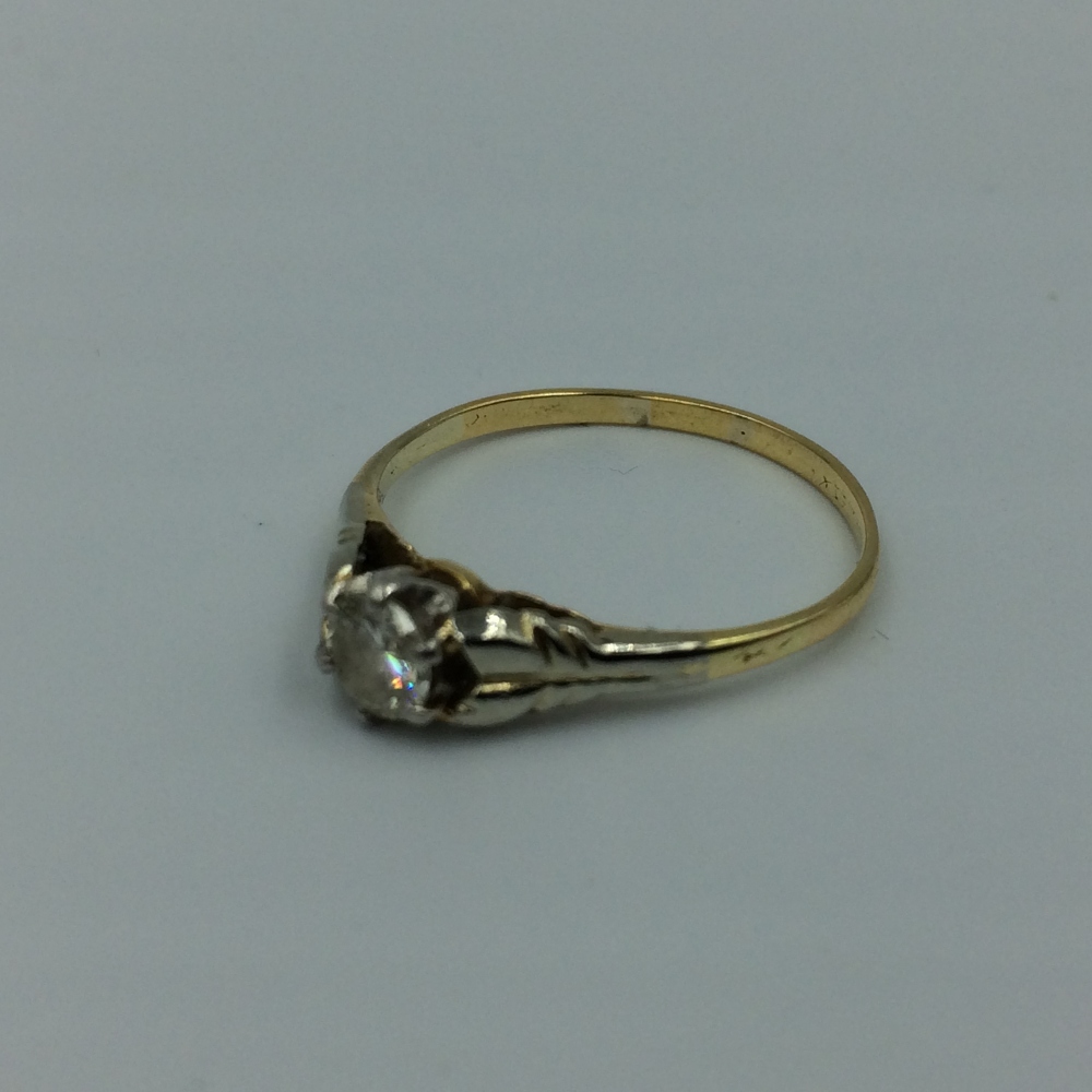 Single stone diamond ring in unmarked yellow & white metal, central brilliant cut diamond approx 0.