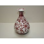 Bulbous Chinese vase decorated with a red floral pattern on a white ground 11cm base 32cm H