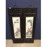 Pair of wooden framed porcelain Chinese panels depicting fishing scenes