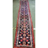 Rug - runner in reds, blue & cream borders with blue centre 488x92cm