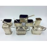 4 sterling silver salts with blue glass liners in the Art Deco style with 2 matching lidded mustards