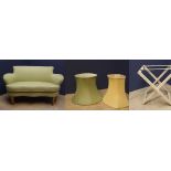 Small 2 seater sofa with green upholstery; an upholstered suitcase stand & 2 lampshades