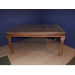 Indian hardwood dining table, the glass top surmounting an old Tibetan door 173Lx98Wx79Hcm