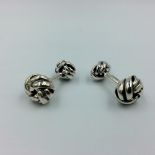 Pair of silver cufflinks in the style of knots