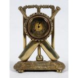 Cricket clock. A Victorian brass mantel clock. The case in the form of a set of stumps with