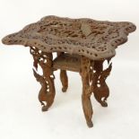 20th Century Thai Carved Teak Wood Table. Relief carving to top, pierced border, and stands on