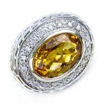 Oval Cut Citrine, Diamond and 14 Karat Yellow Gold Ring. Citrine measures 14mm x 10mm. Stamped