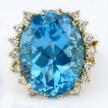 Vintage Oval Cut London Blue Sapphire, Diamond and 14 Karat Yellow Gold Ring. Topaz measures 20.5
