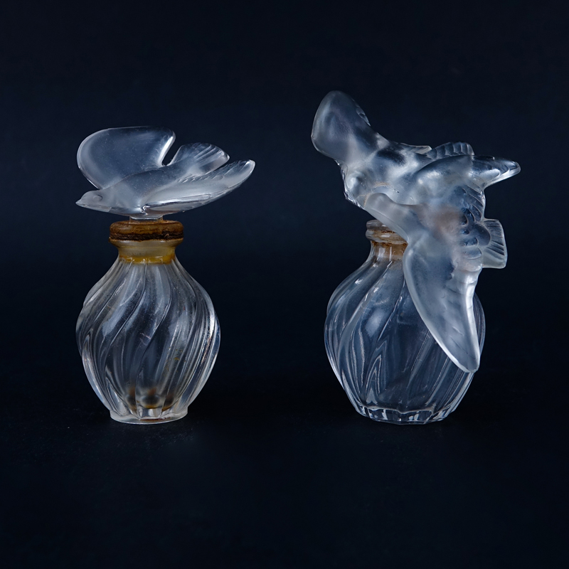 Two (2) Lalique for Nina Ricci L'air du Temps Perfume Bottles. Each signed appropriately. One stopp