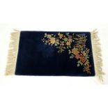 Chinese Nichols Rug, Navy Blue with Flowers. Needs cleaning, wear and stains to fringes. Measures 3