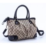 Gucci Beige Monogram Canvas And Leather Sukey PM Bag. Gold tone hardware. Interior of beige canvas