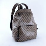 Gucci Beige Monogram Coated Canvas Travel Backpack. Gold hardware. Brown fabric interior with zippe