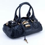 Chloe Black Grained Leather Paddington MM Handbag. Brushed gold tone hardware. The interior of blac