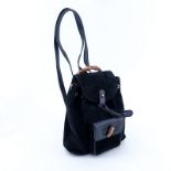 Gucci Black Suede And Leather Bamboo PM Backpack. Brushed gold hardware. Interior of signature fabr