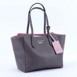 Gucci Taupe/Light Pink Grained Leather Swing PM Handbag. Gold tone hardware, interior of beige fabr